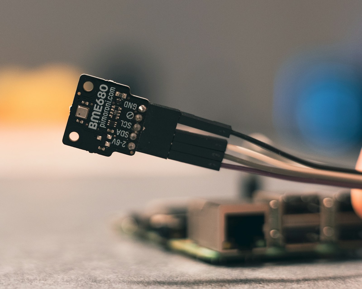 Macro shot of an environmental sensor board with wiring, representing multi-sensor integration